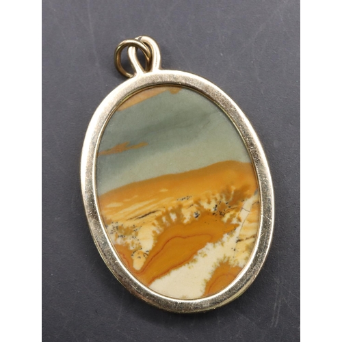 545 - A gold coloured metal oval agate coloured stone pendant, 5cm high