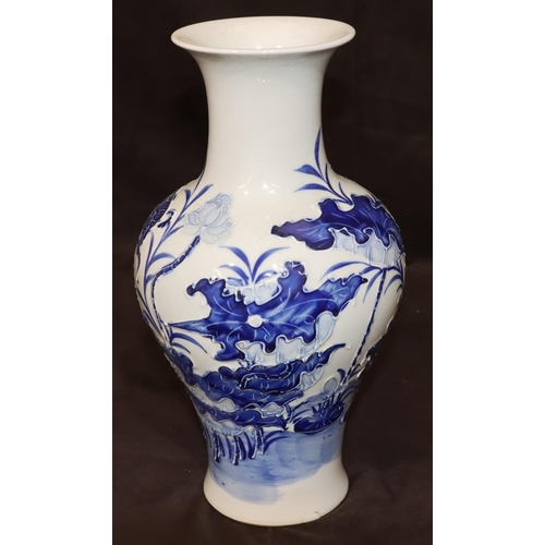 55 - An Oriental round bulbous thin necked trumpet shaped vase with raised blue fish, floral and leaf dec... 