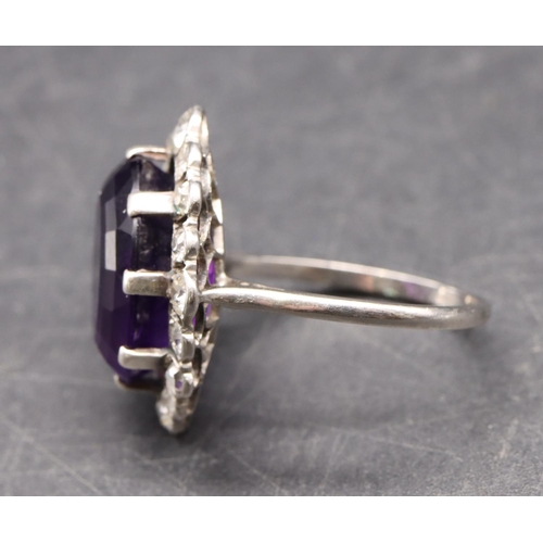 551 - A platinum ladies' large cluster ring set with centre amethyst surrounded by 16 diamonds, size S/T, ... 