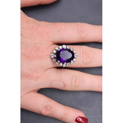 551 - A platinum ladies' large cluster ring set with centre amethyst surrounded by 16 diamonds, size S/T, ... 