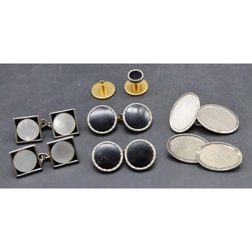 557 - A pair of silver gentleman's oval cufflinks, 2 other pairs of cufflinks and single dress stud (7)