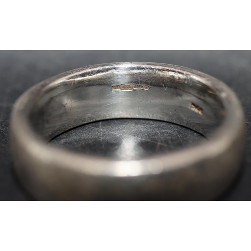 572 - A silver wedding ring, size U and a child's silver bangle. (2)