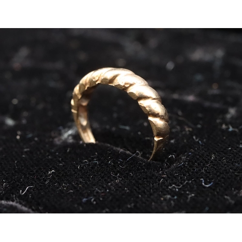 573 - A 9ct gold ring with twist decoration, size K/L, 1.8 grams