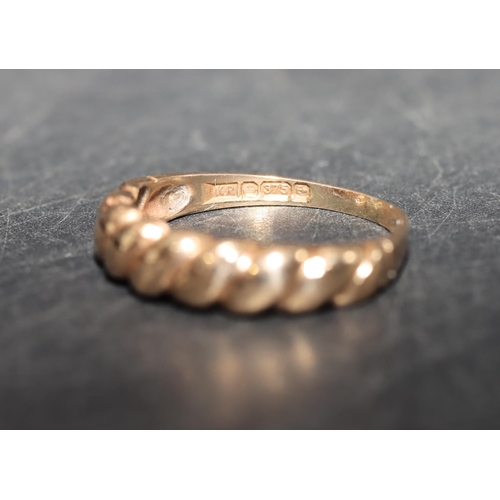 573 - A 9ct gold ring with twist decoration, size K/L, 1.8 grams