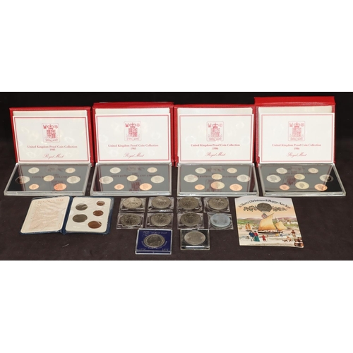 582 - A set of 4 Royal Mint United Kingdom coin collection sets in red cases, 2 x 1985, 2 x 1986 and an Am... 