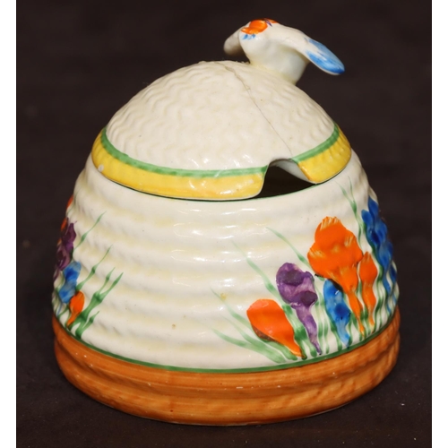 60 - A Clarice Cliff Bizarre Crocus pattern jam pot in the form of a beehive with cover (cover cracked), ... 