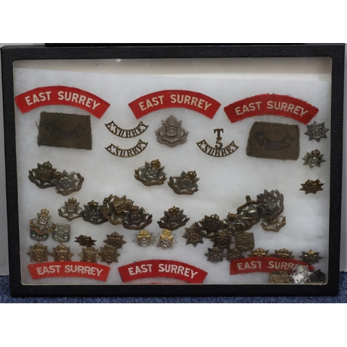 642 - Various East Surrey Military Regiment badges etc. all in single frame and another framed set (2)