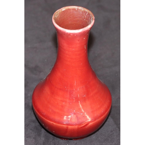 69 - A Liberty small Flambé round bulbous thin necked vase on red ground, 14.5cm high