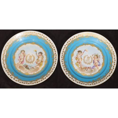 72 - A pair of 19th Century Sevres round plates on turquoise and white ground with multi-coloured cupid, ... 