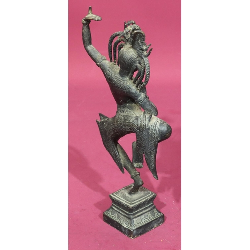 736 - An Eastern bronze figure of a lady dancer on square platform base, 32cm high