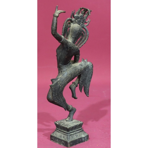 736 - An Eastern bronze figure of a lady dancer on square platform base, 32cm high