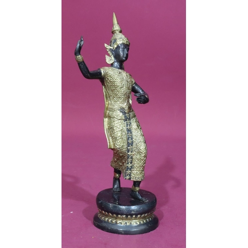 737 - An Eastern bronze and gilt metal figure of a female dancer on round base, 29.5cm high