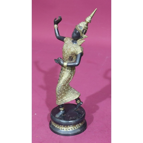 737 - An Eastern bronze and gilt metal figure of a female dancer on round base, 29.5cm high