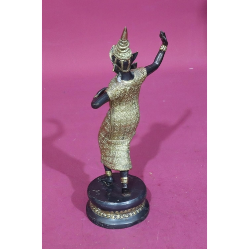 737 - An Eastern bronze and gilt metal figure of a female dancer on round base, 29.5cm high