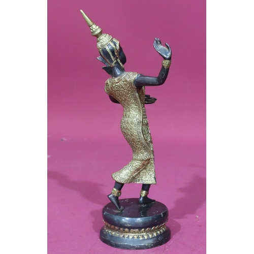 737 - An Eastern bronze and gilt metal figure of a female dancer on round base, 29.5cm high