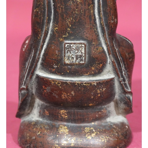 738 - An Oriental bronze figure of a seated Buddha with allover gilt fleck decoration, stamp to back of ba... 