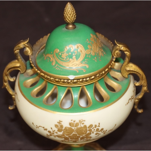 74 - A Sevres porcelain and ormolu round bulbous thin necked lidded potpourri on white and green ground w... 