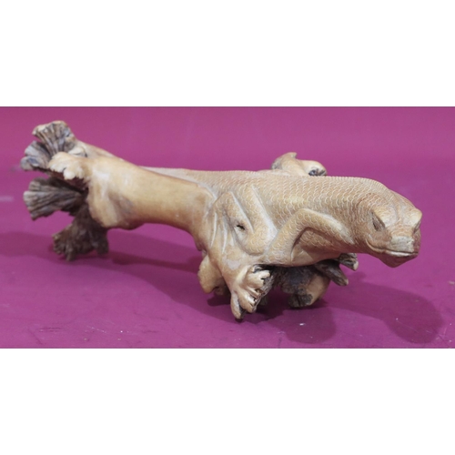 741 - A carved wooden branch in the form of a lizard, 35cm long