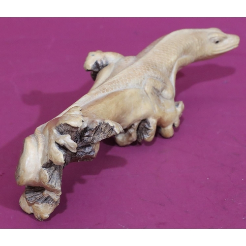 741 - A carved wooden branch in the form of a lizard, 35cm long