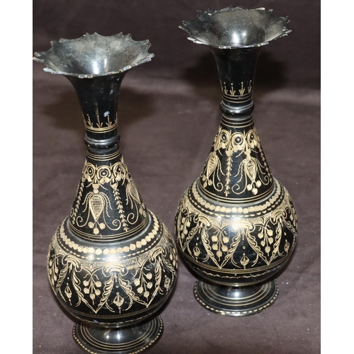 742 - A pair of metal round bulbous thin necked trumpet shaped vases on black ground with gilt, swag, flor... 