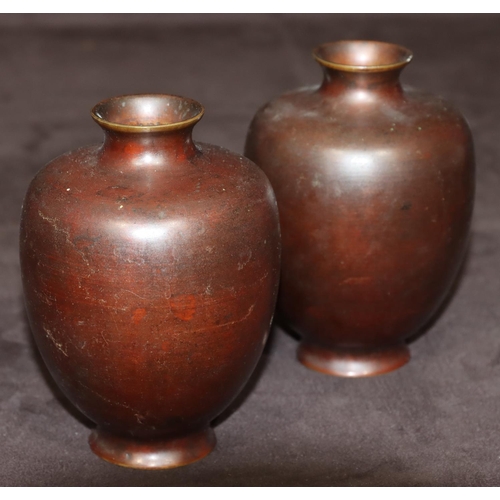 743 - A pair of bronze small round bulbous thin necked vases, 12cm high