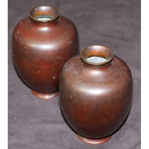 743 - A pair of bronze small round bulbous thin necked vases, 12cm high