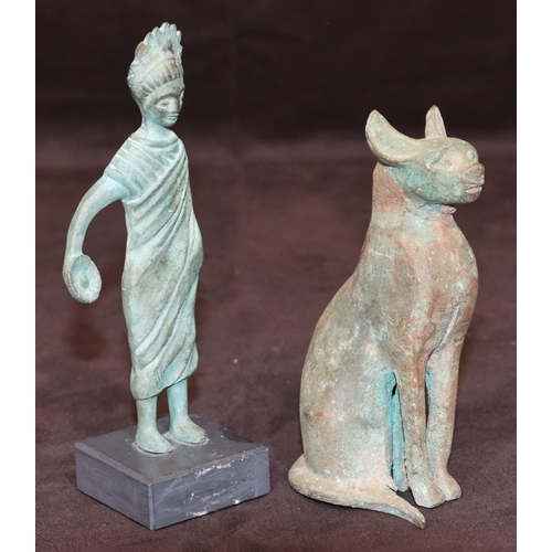 745 - An Eastern bronze figure of a cat, 14cm high and a small bronze standing figure on square black slat... 