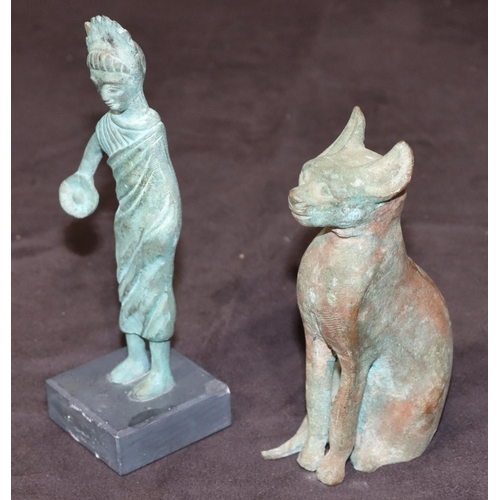 745 - An Eastern bronze figure of a cat, 14cm high and a small bronze standing figure on square black slat... 