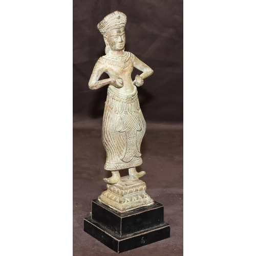 747 - An Eastern bronze figure of a standing lady on square base with further square ebonised platform bas... 