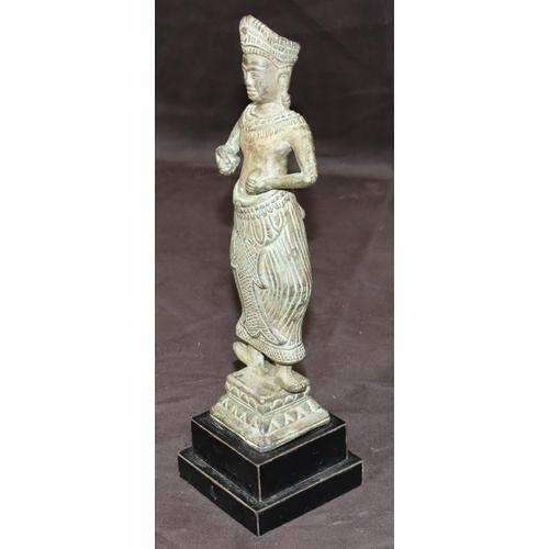 747 - An Eastern bronze figure of a standing lady on square base with further square ebonised platform bas... 