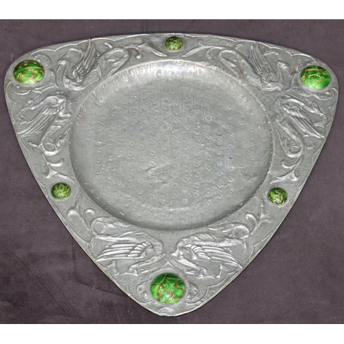 755 - An Arts Nouveau triangular hammered pewter dish with raised green carbuncles and bird motifs, 32cm w... 