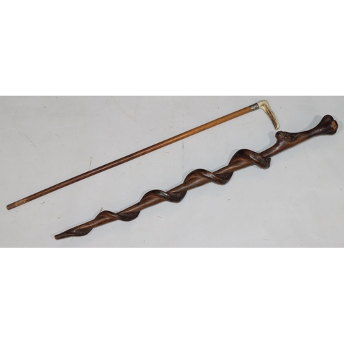 777 - A carved walking stick with raised serpent motif, 91cm long and another walking cane with horn handl... 