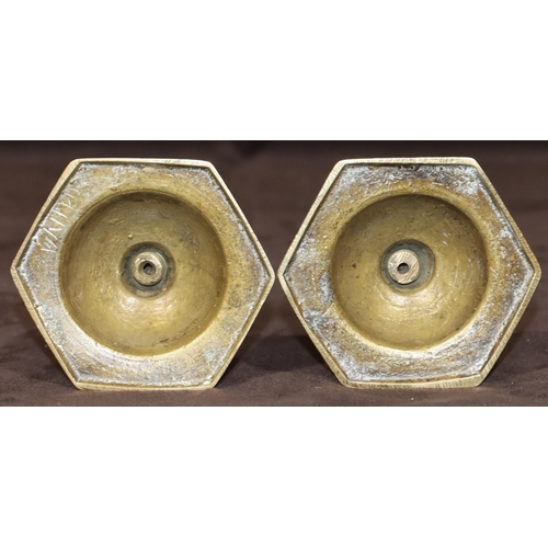 780 - A pair of Oriental small brass candlesticks on square turned stem with hexagonal bases, 20cm high