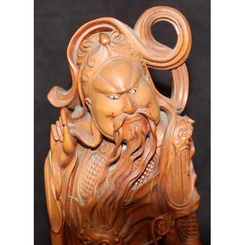 784 - An Oriental carved wooden figure of a standing Samurai warrior, 31cm high