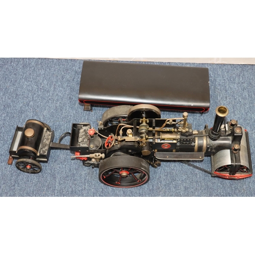 793 - A live model steam traction engine on black ground with separate trailer, gas fired, engine 50cm lon... 