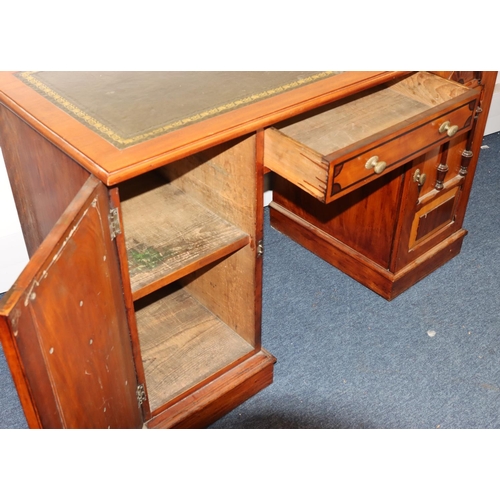 808 - A late Victorian kneehole desk with green leather inset top, part inlay decoration, centre drawer fl... 