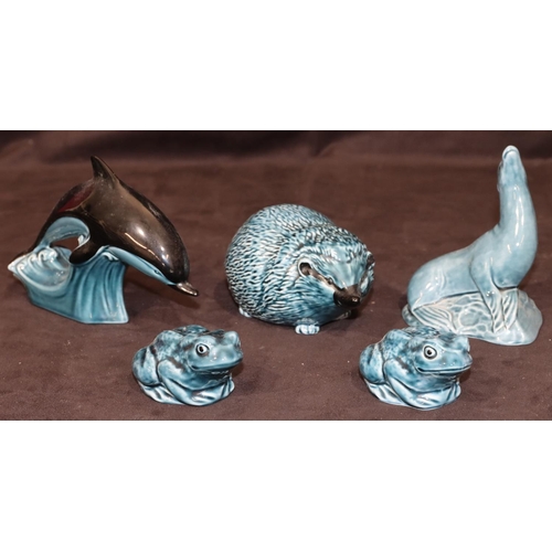 81 - A Poole blue china figure of a hedgehog, a similar figure of a seal, a similar dolphin and 2 similar... 