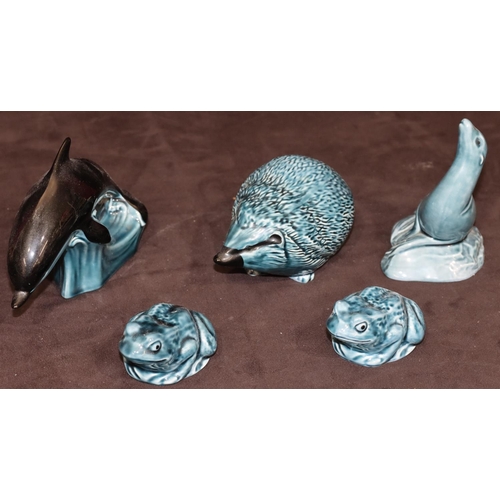 81 - A Poole blue china figure of a hedgehog, a similar figure of a seal, a similar dolphin and 2 similar... 