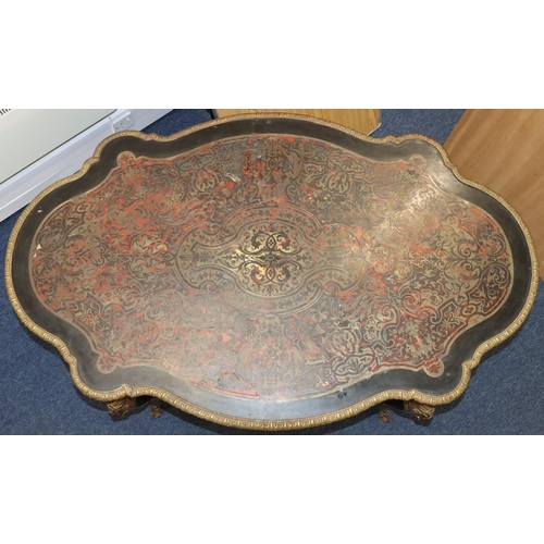 815 - A 19th Century Boulle scallop shaped writing table with allover raised figurehead, leaf and scroll d... 