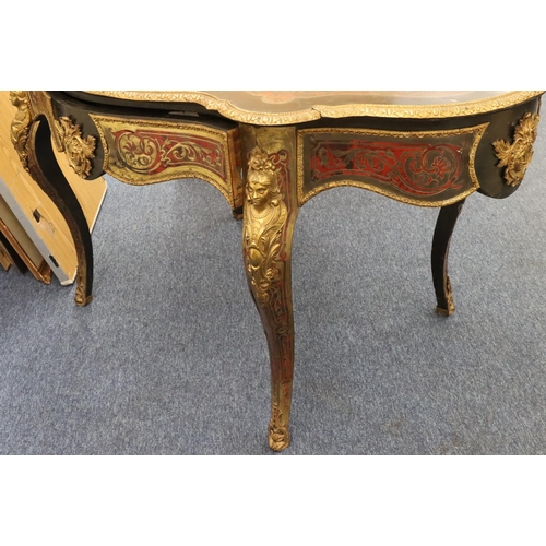 815 - A 19th Century Boulle scallop shaped writing table with allover raised figurehead, leaf and scroll d... 