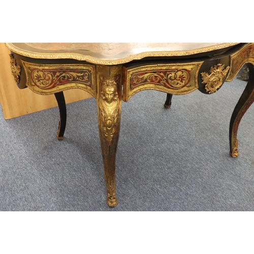 815 - A 19th Century Boulle scallop shaped writing table with allover raised figurehead, leaf and scroll d... 