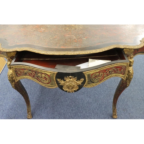 815 - A 19th Century Boulle scallop shaped writing table with allover raised figurehead, leaf and scroll d... 