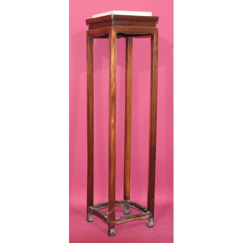 818 - An Oriental hardwood square Torchère with white marble top on square legs, 165cm high