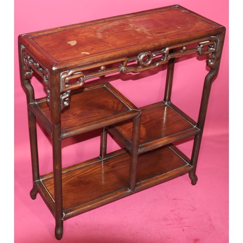 822 - An Oriental hardwood rectangular shaped stand with pierced frieze, 2 under tiers, on round splayed l... 