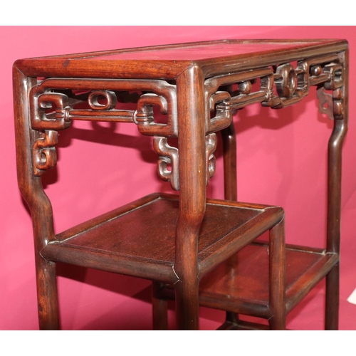 822 - An Oriental hardwood rectangular shaped stand with pierced frieze, 2 under tiers, on round splayed l... 