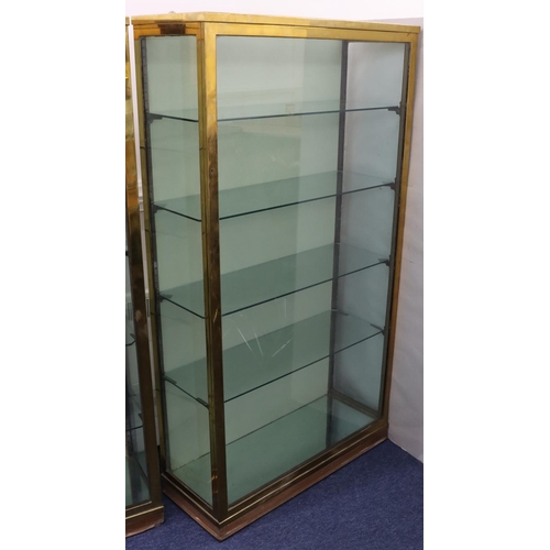 826 - A 19th/20th Century heavy brass and glass display cabinet with single glass door and sides enclosing... 