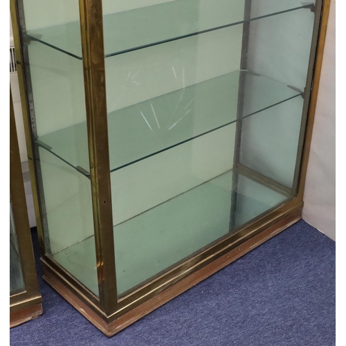 826 - A 19th/20th Century heavy brass and glass display cabinet with single glass door and sides enclosing... 