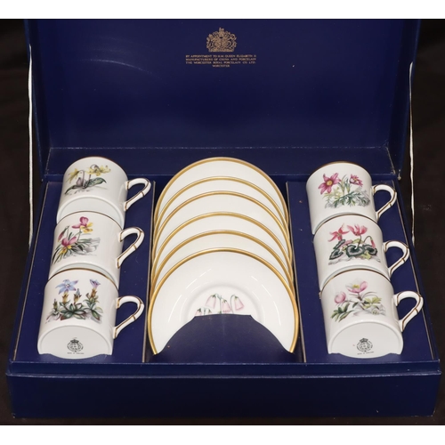 84 - A set of 6 Royal Worcester coffee cans and saucers on white ground with various multi-coloured flora... 