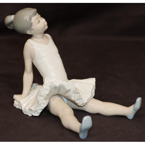 85 - A Nao figure of a seated young ballerina, 14.5cm high