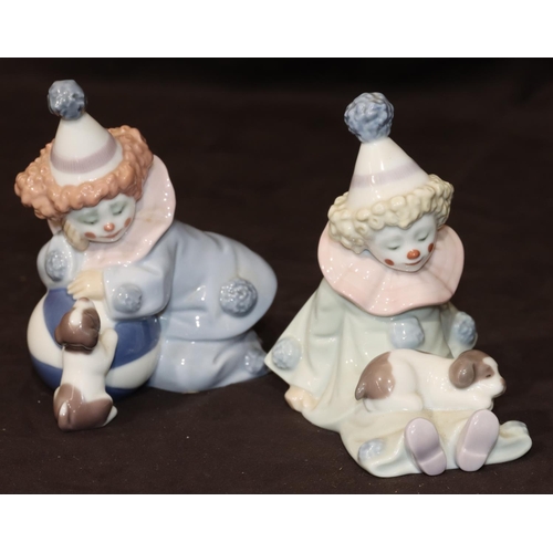 86 - A pair of Lladro figures of seated clown, children with puppies, largest 12cm high